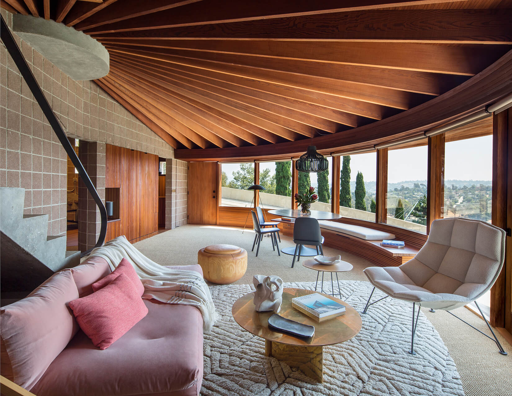photograph depicting a rounded living room in a midcentury hillside Los Angeles home