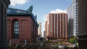 由高架火车轨道和历史建筑环绕的住宅塔的渲染