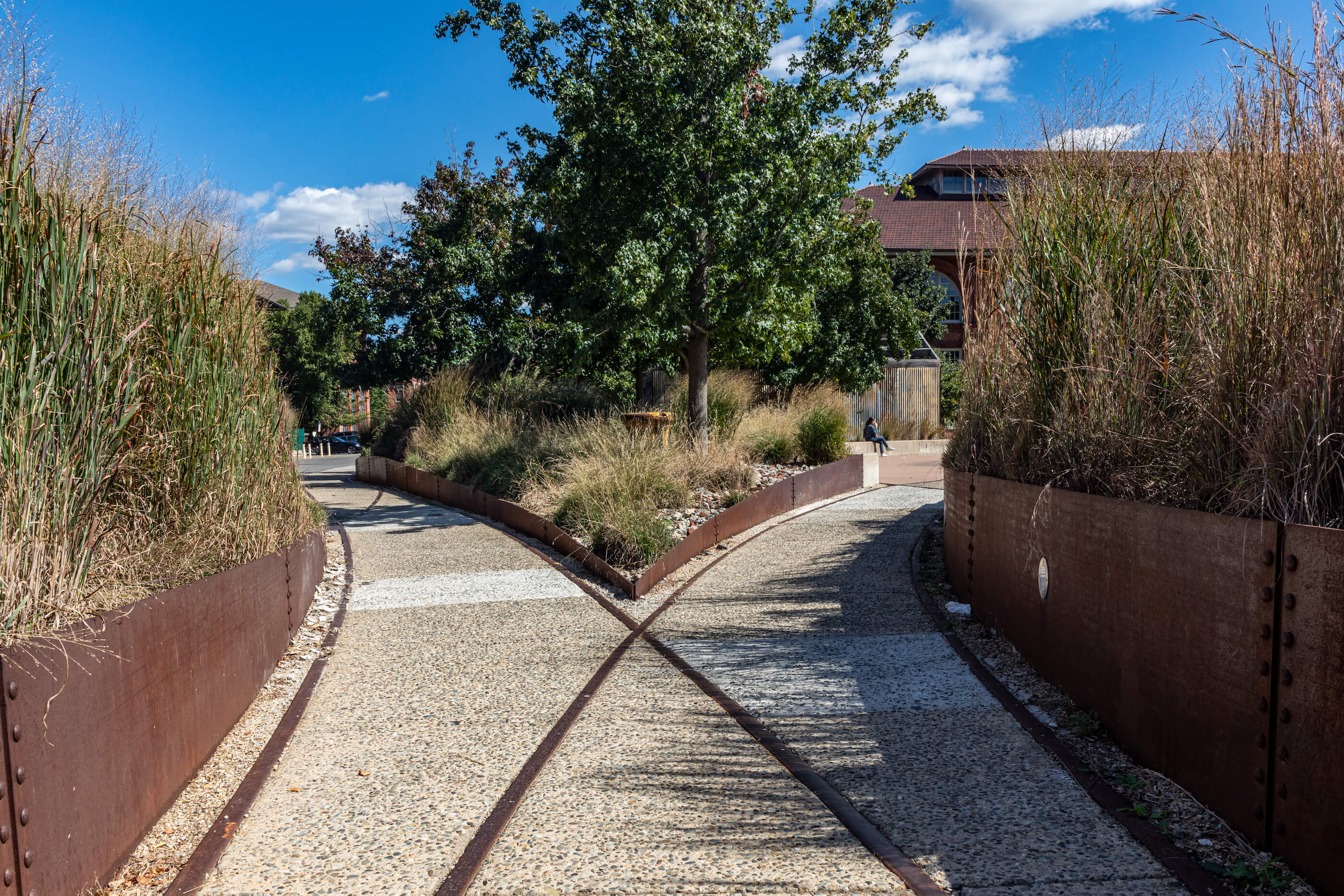 a corporate campus with uncovered old railway tracks