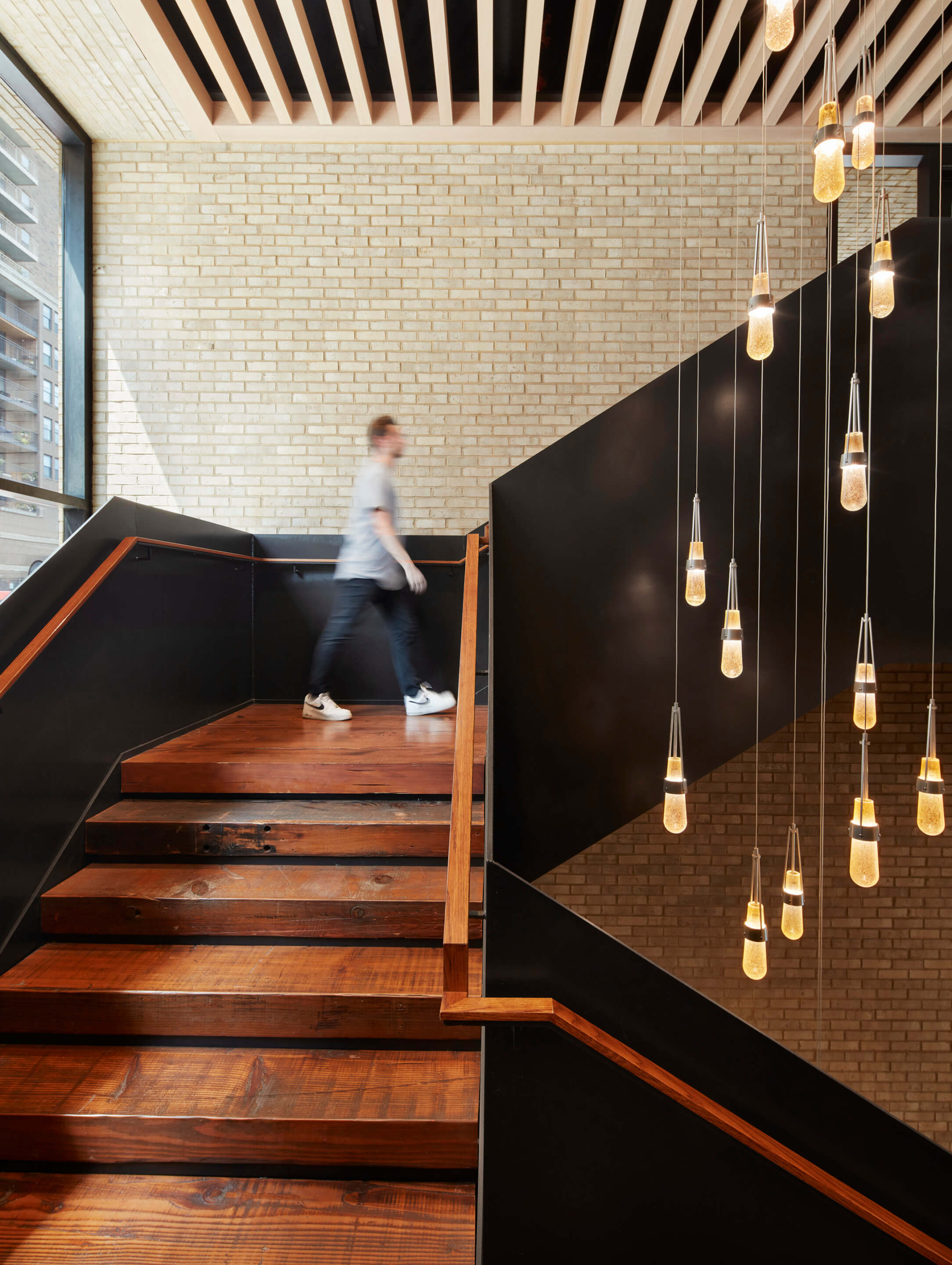 A staircase with pendant lights