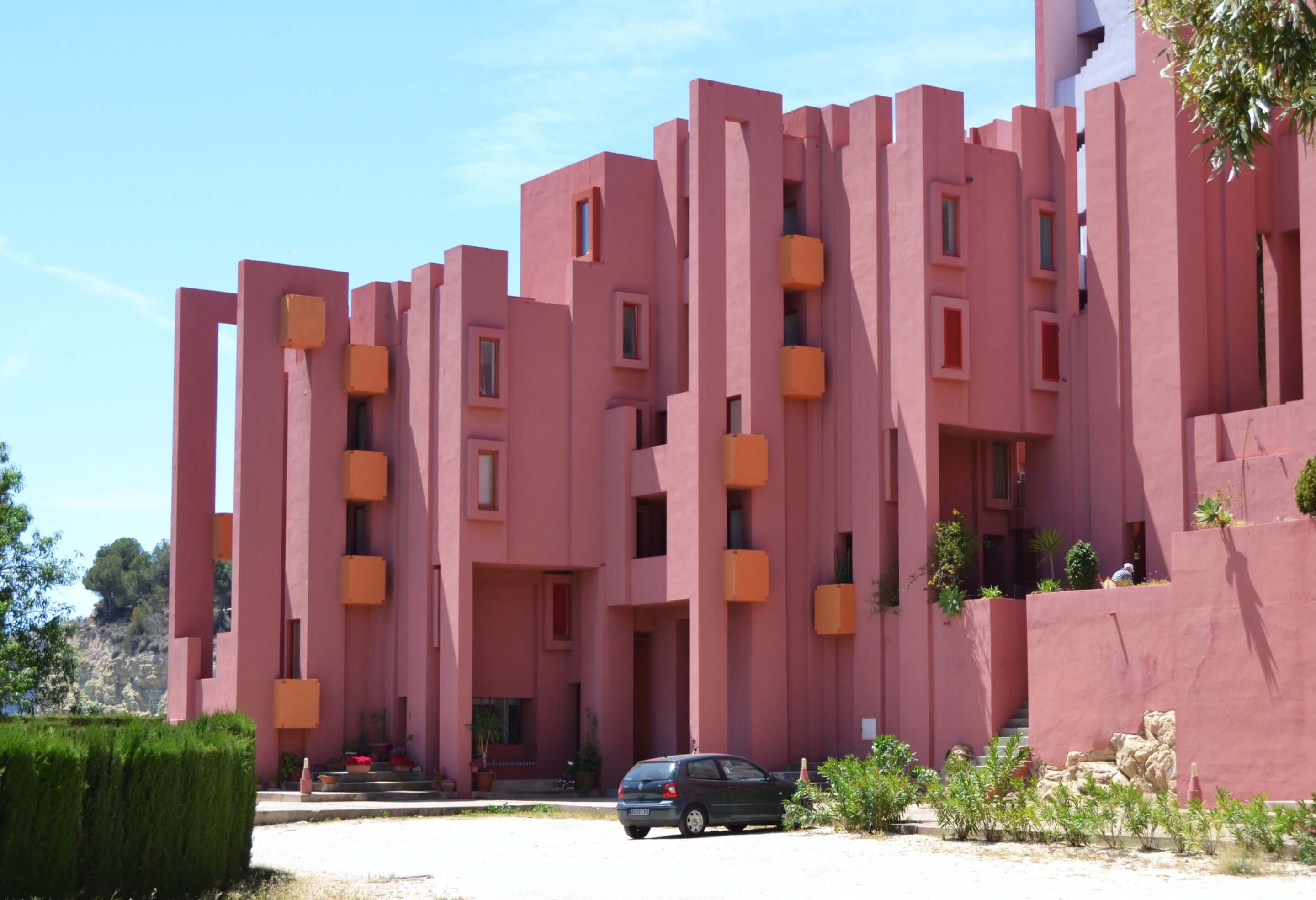 La Muralla Roja, designed by ricardo bofill, a bright red collection of towers