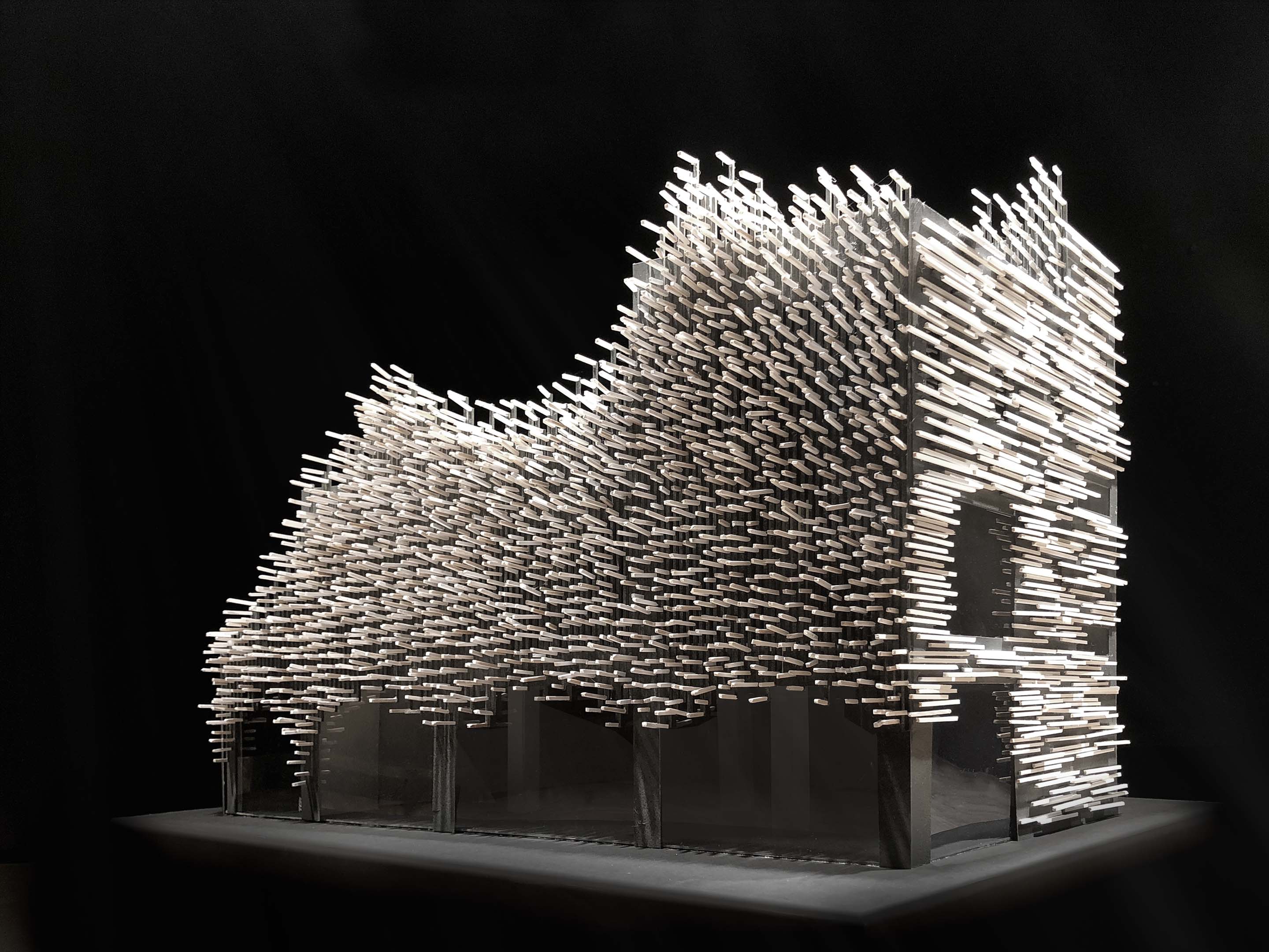 A scale model of a wave-like building with aluminum rods all over