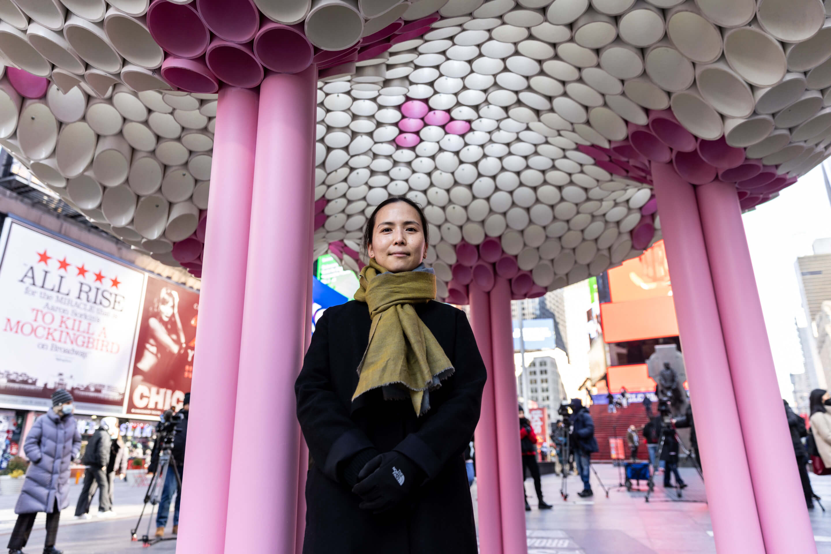 a designer stands in front of a temporary valentine's day installation